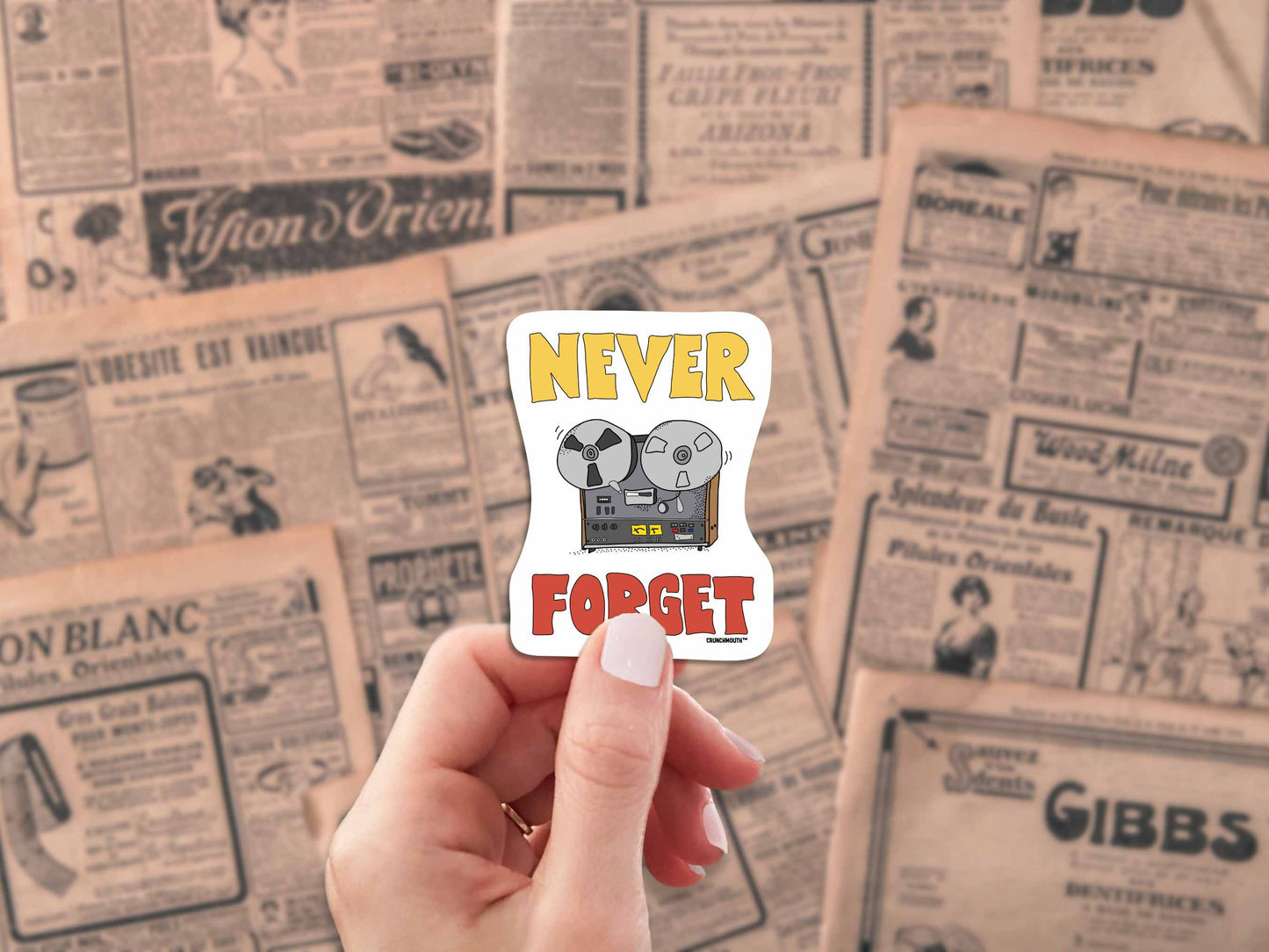 reel-to-reel player never forget sticker, hand display, antique newspaper ads background