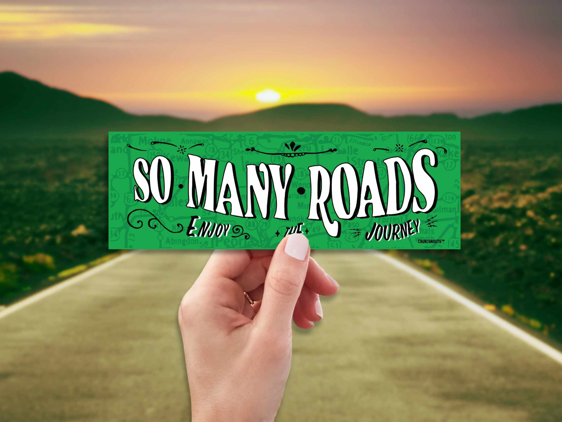 so many roads bumper sticker, hand display, highway landscape background