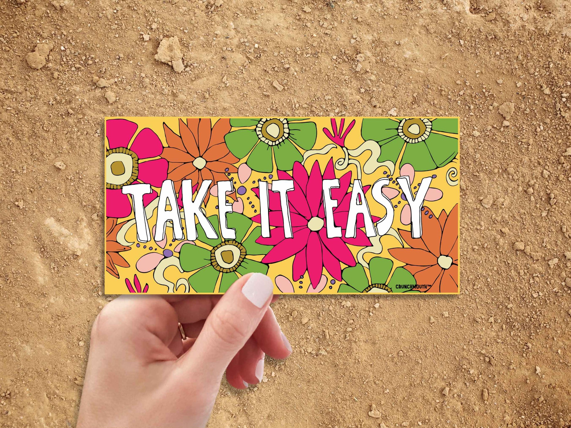 take it easy bumper sticker, hand display, dirt road background