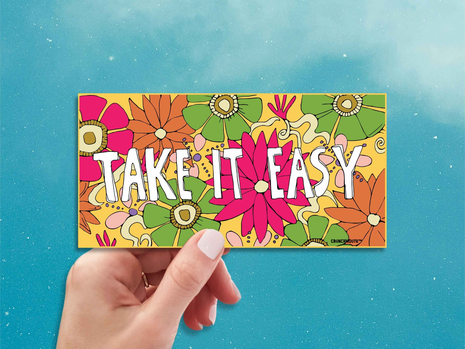 take it easy bumper sticker, hand display, blue sky background