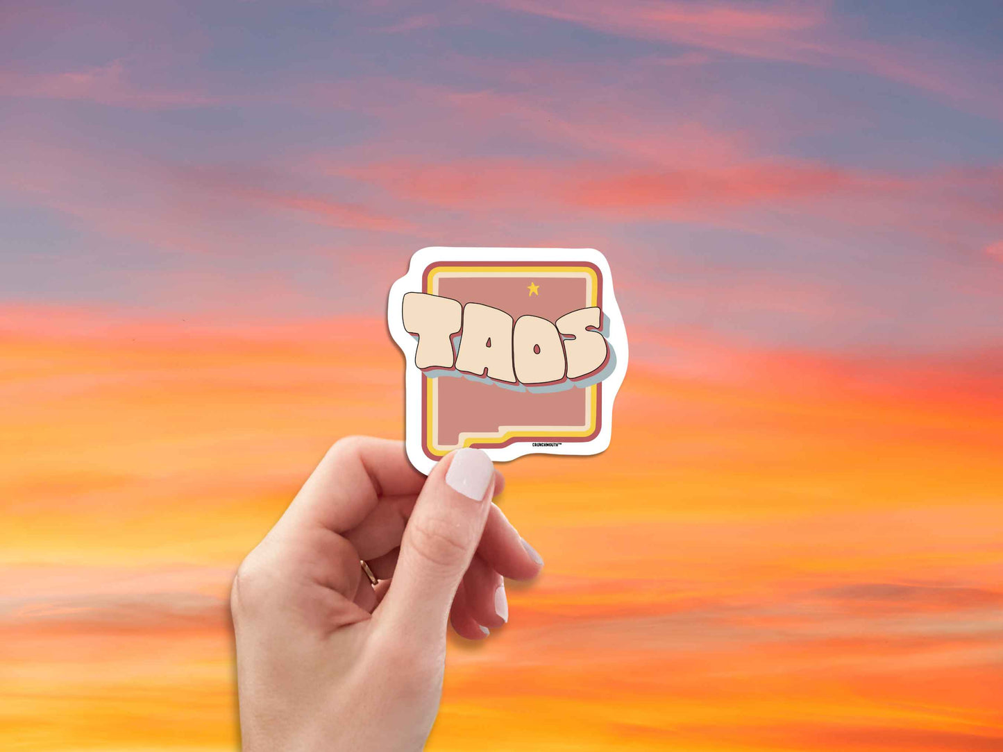 taos travel luggage sticker, hand display, red sky background