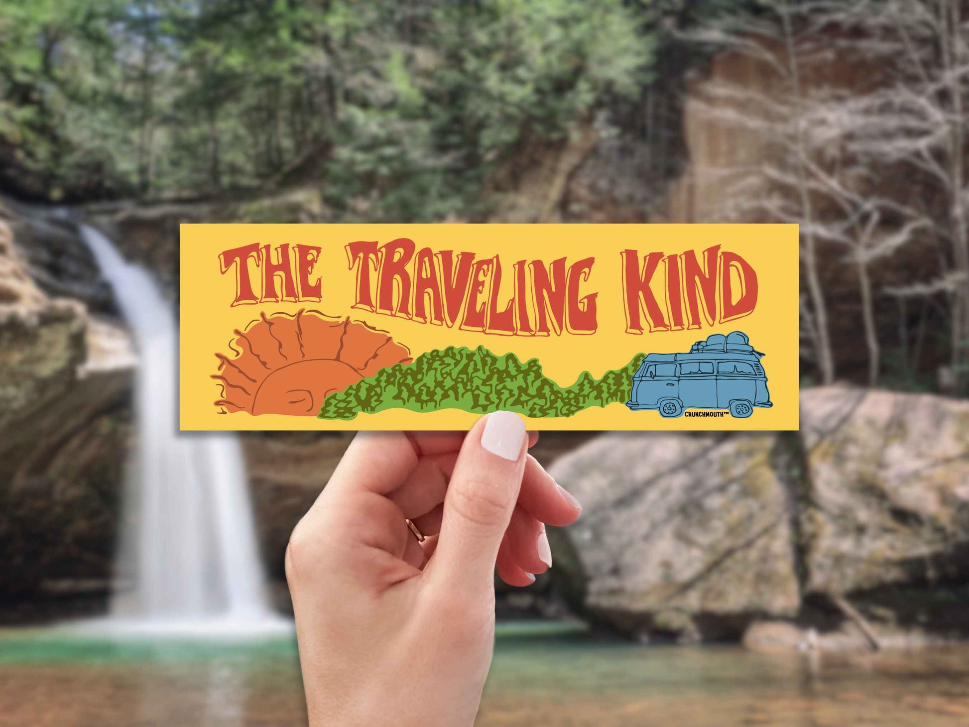 the traveling kind bumper sticker, hand display, waterfall background