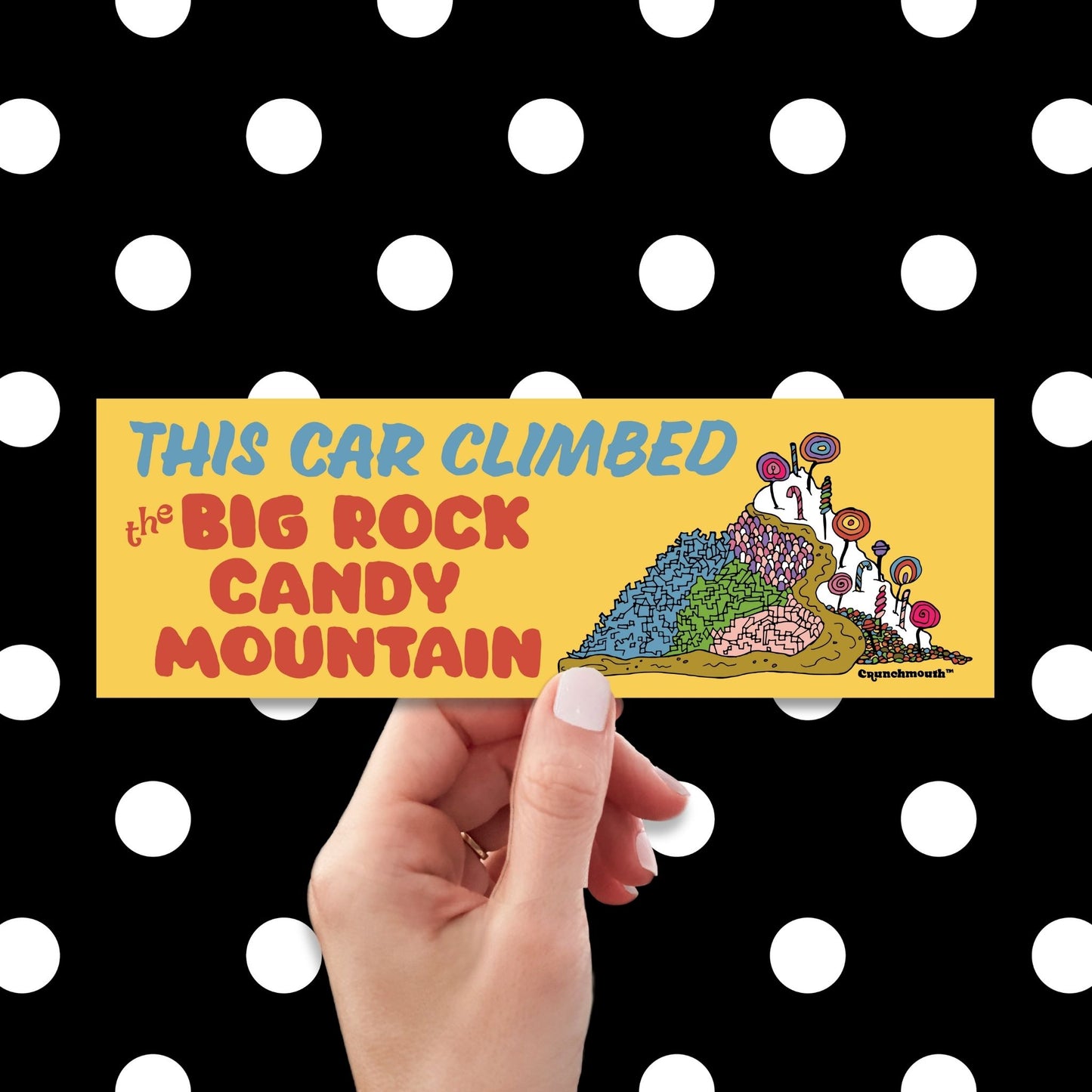 this car climbed the big rock candy mountain bumper sticker, hand display, polka dot background