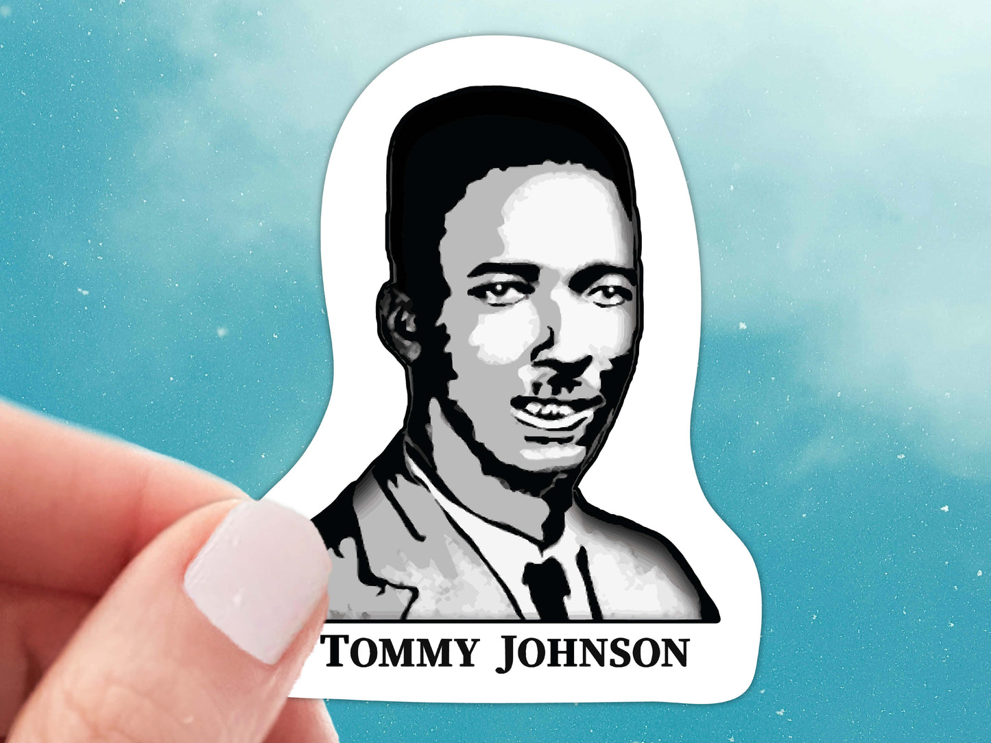 tommy johnson vinyl sticker, hand display, blue sky background
