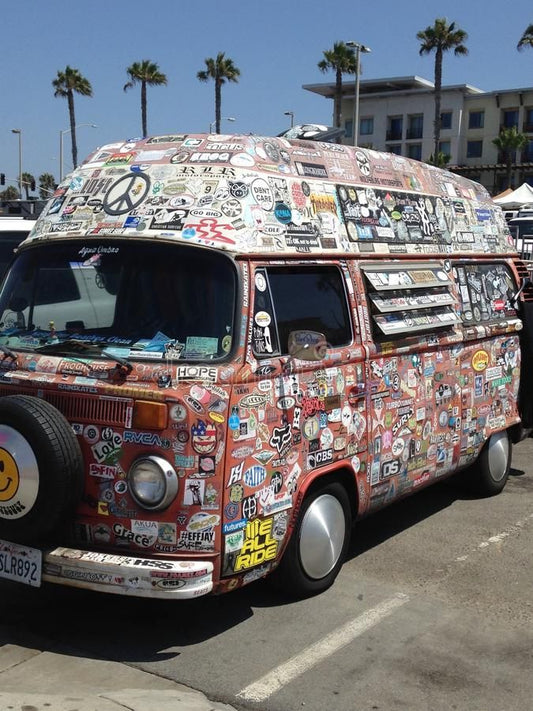 hippie van with bumper stickers on it