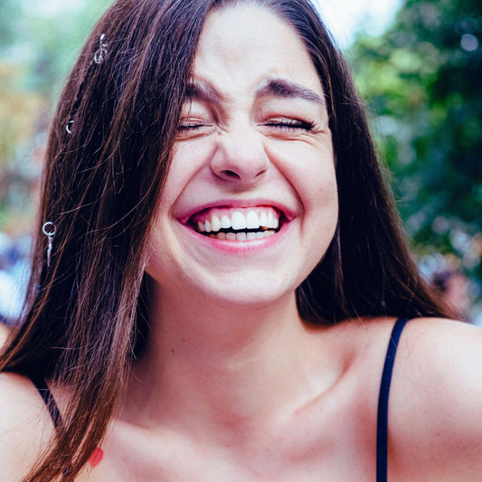 happy girl laughing at funny bumper sticker