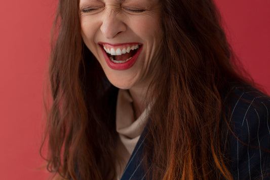 woman laughing, red background