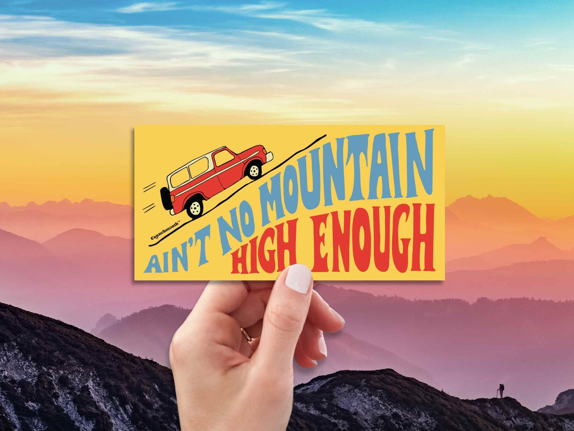 aint no mountain high enough bumper sticker, hand display, mountain sky background