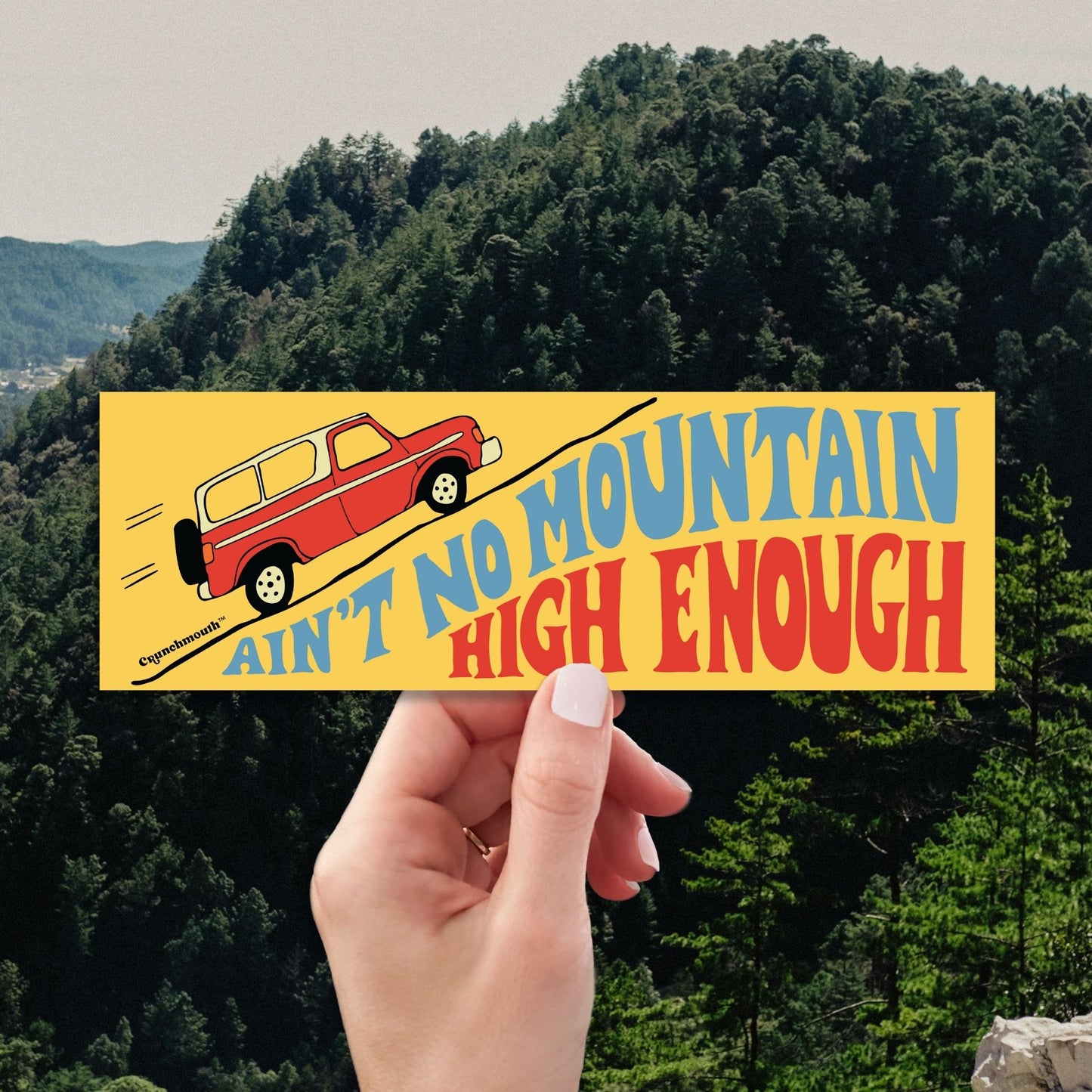 aint no mountain high enough bumper sticker, hand display, mountains background