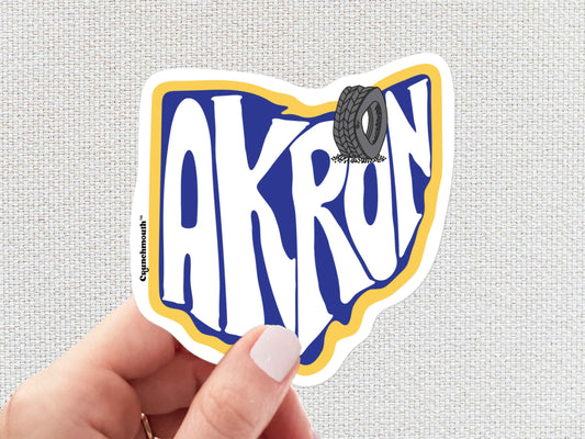 akron sticker, rubber capital of the world, travel luggage stickers, hand display, white textured background