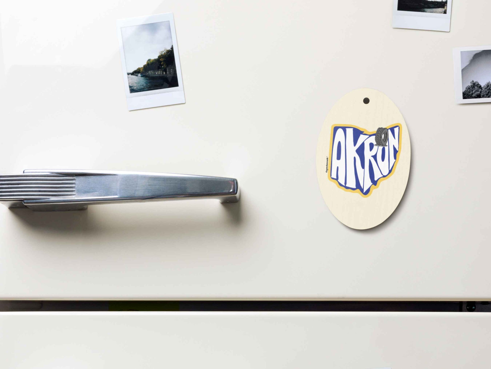 akron Christmas ornament, front bottom left side, magnet displayed on metal file cabinet