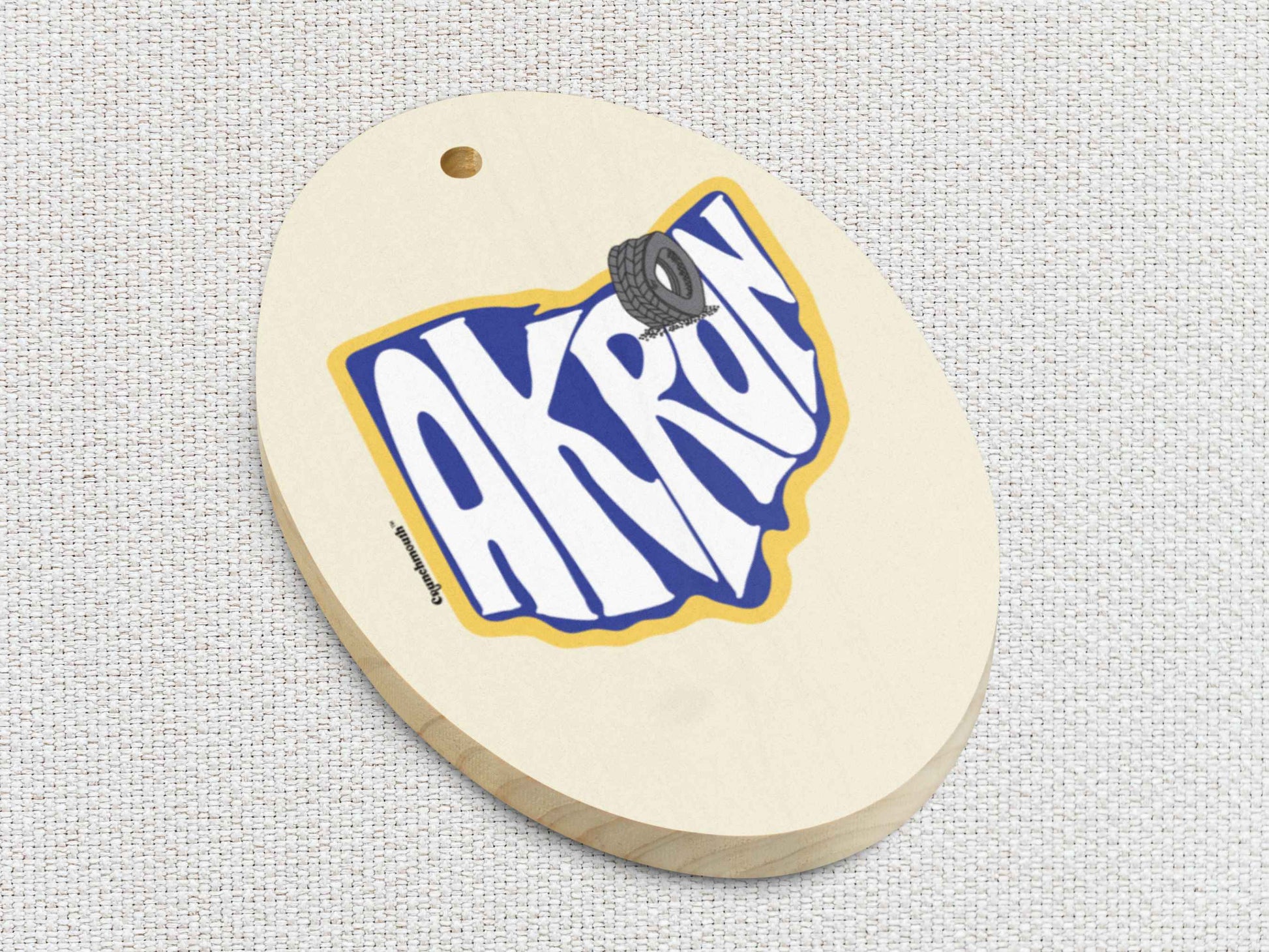 akron Christmas ornament, front bottom left side, white textured background