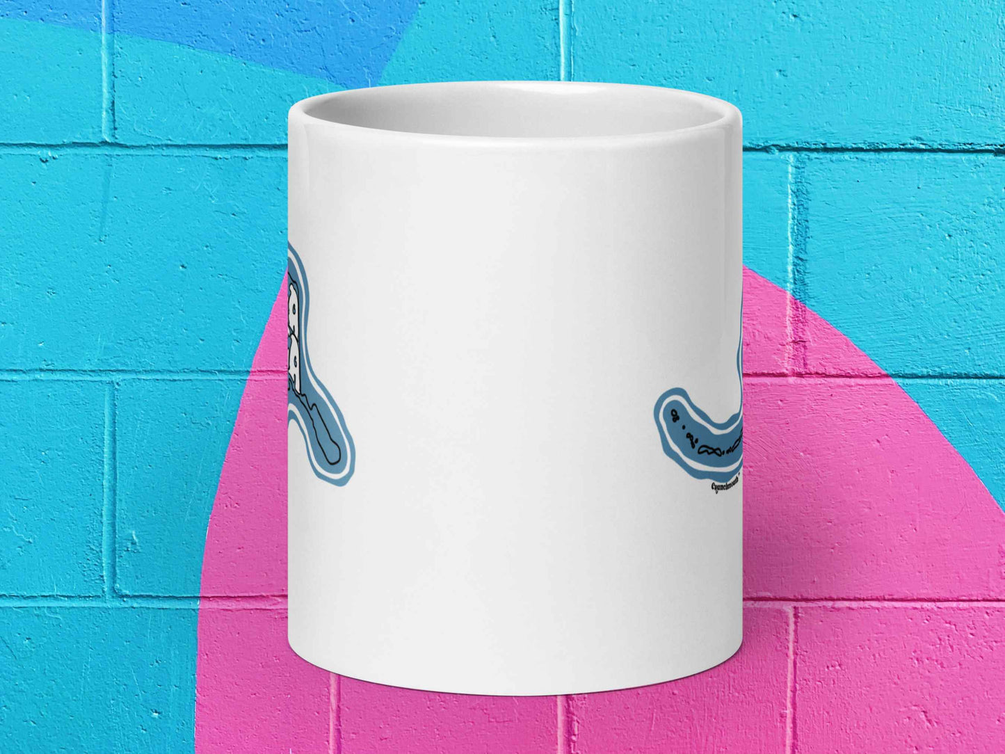 alaska coffee mug, souvenir mugs, 20 oz, front view, vibrant color cinder block wall background