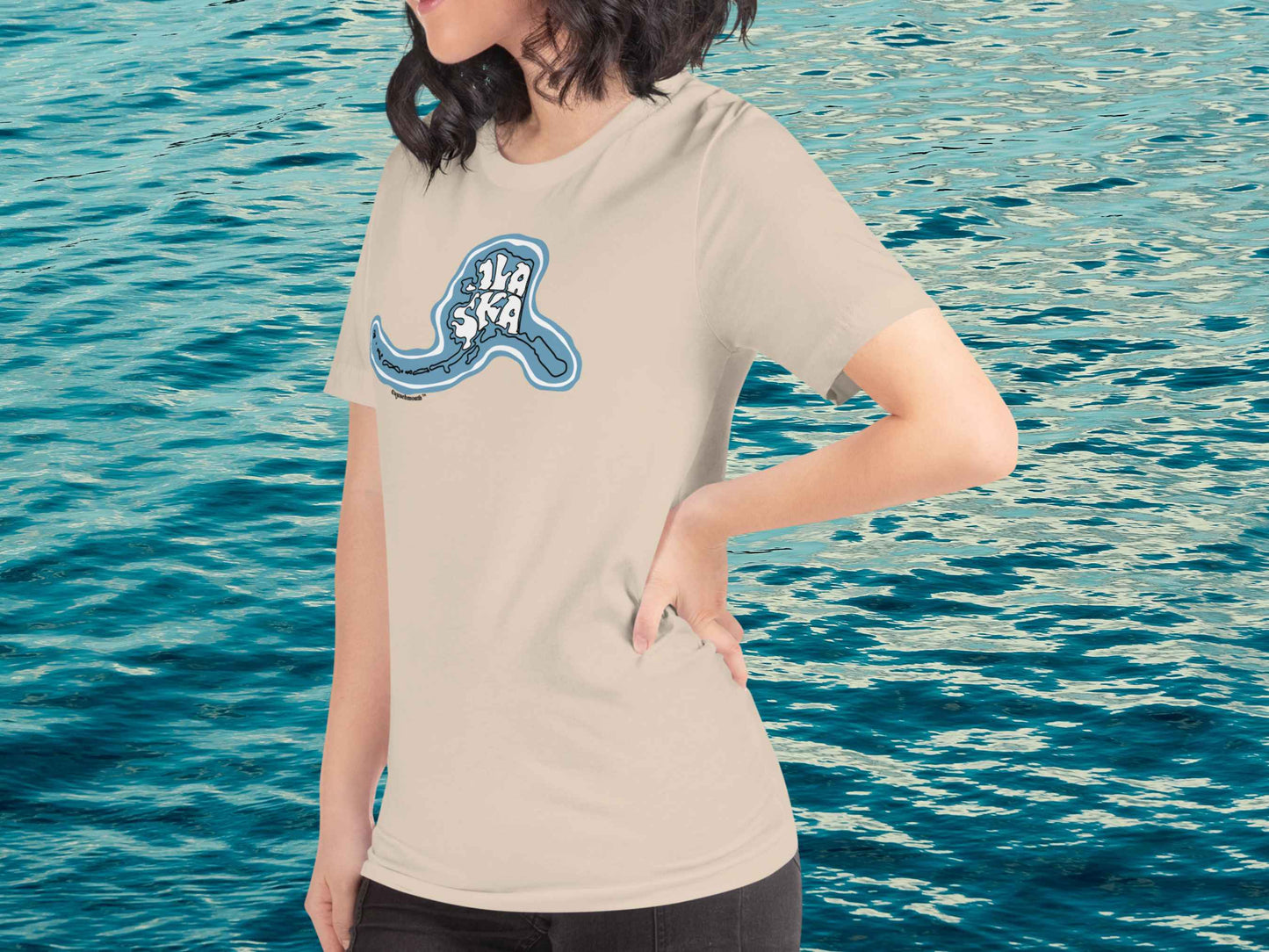 alaska t shirt, souvenir shirts, left front, female model, blue ocean water background