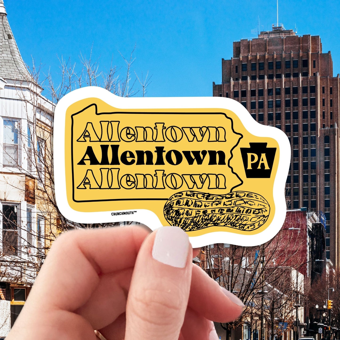 allentown travel luggage sticker, hand display, cityscape background