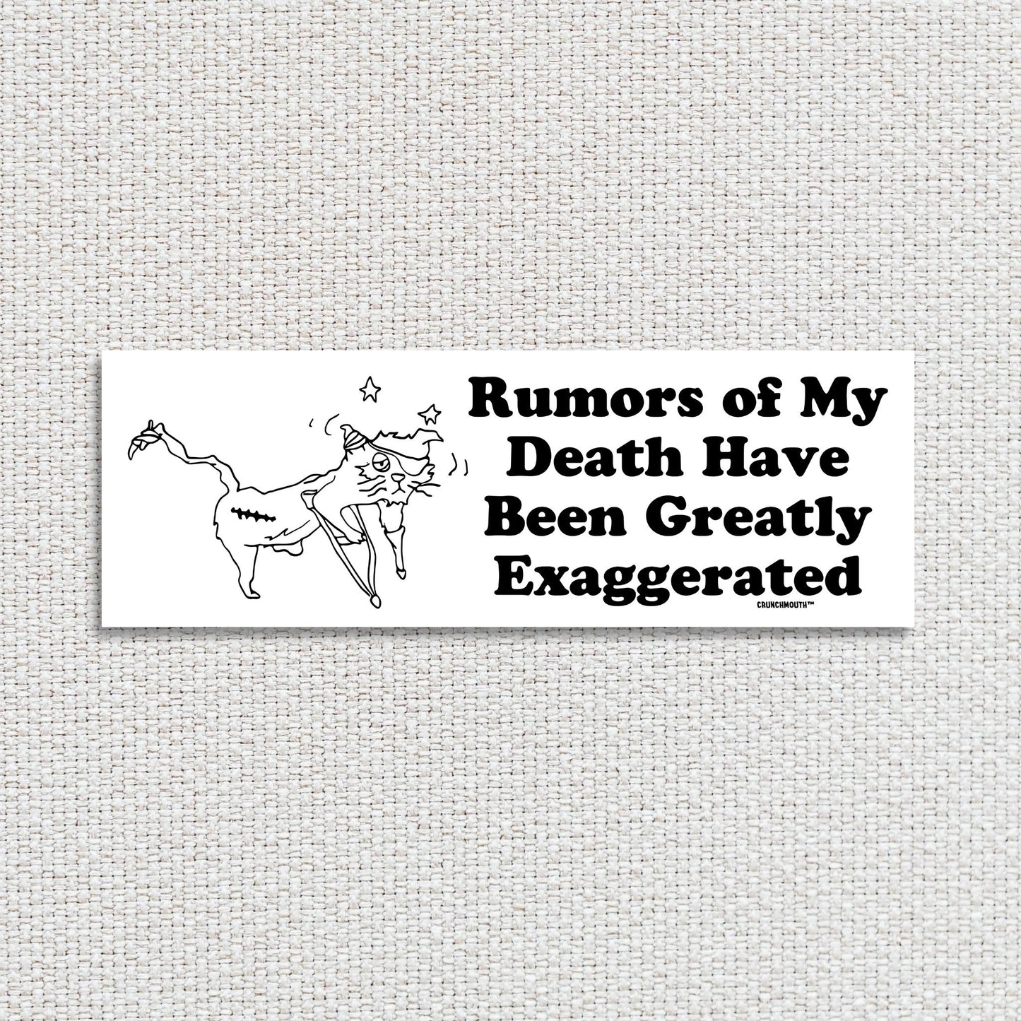 rumors of my death have been greatly exaggerated bumper sticker, textured fabric background
