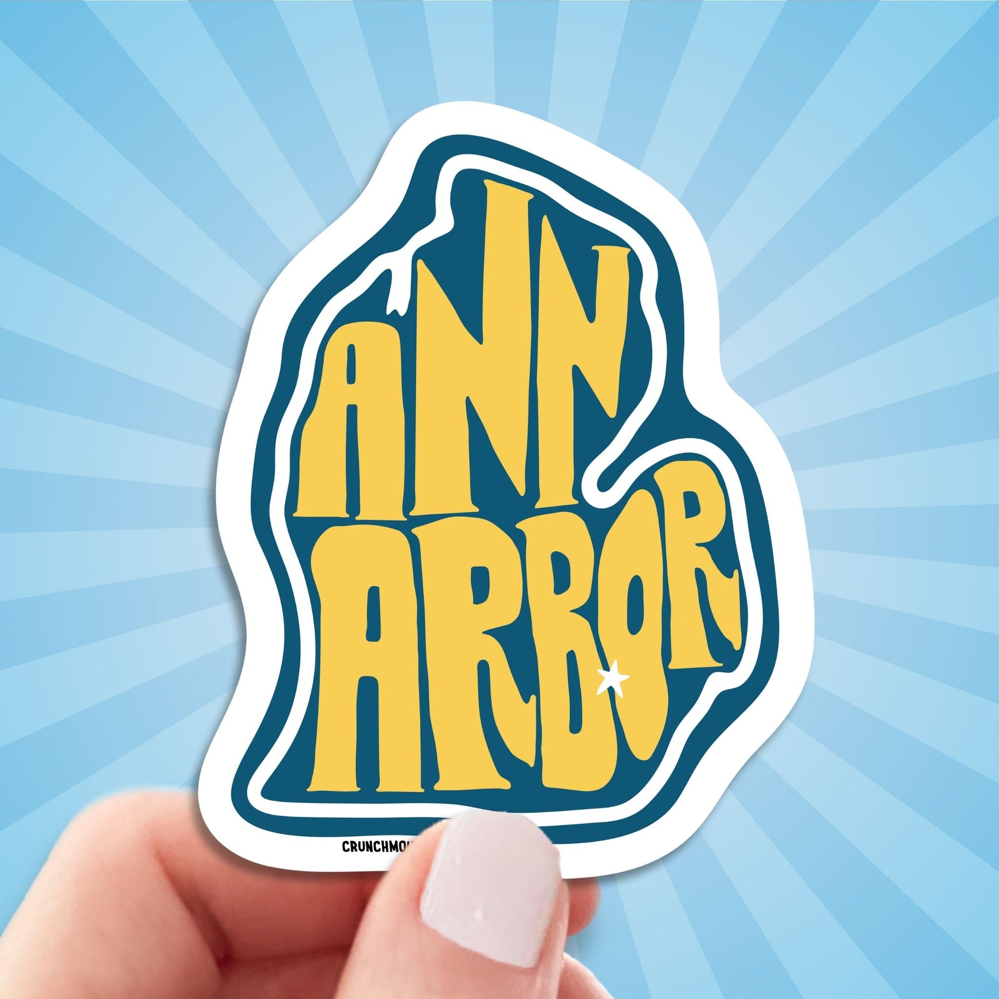 ann arbor travel luggage sticker, hand display, sun rays pattern background