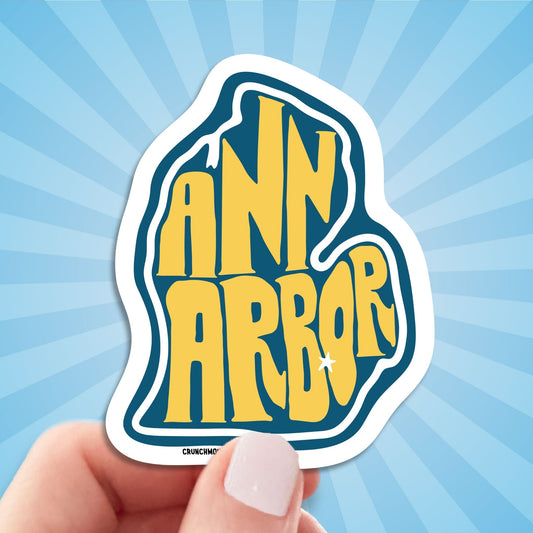 ann arbor travel luggage sticker, hand display, sun rays pattern background