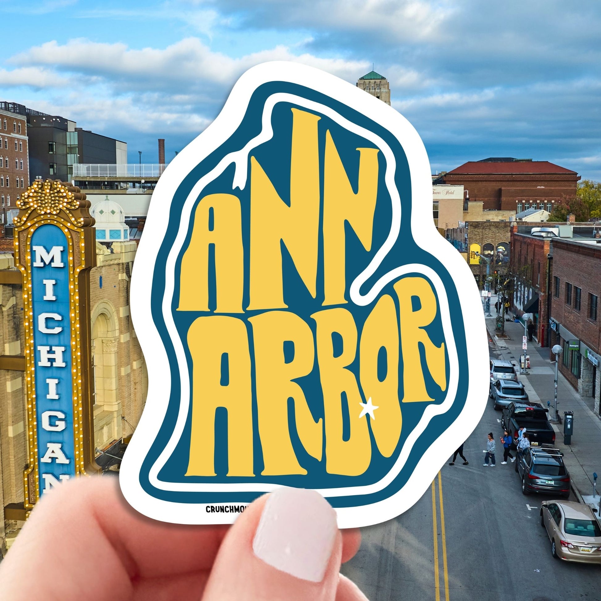 ann arbor travel luggage sticker, hand display, aerial view of ann arbor city street background