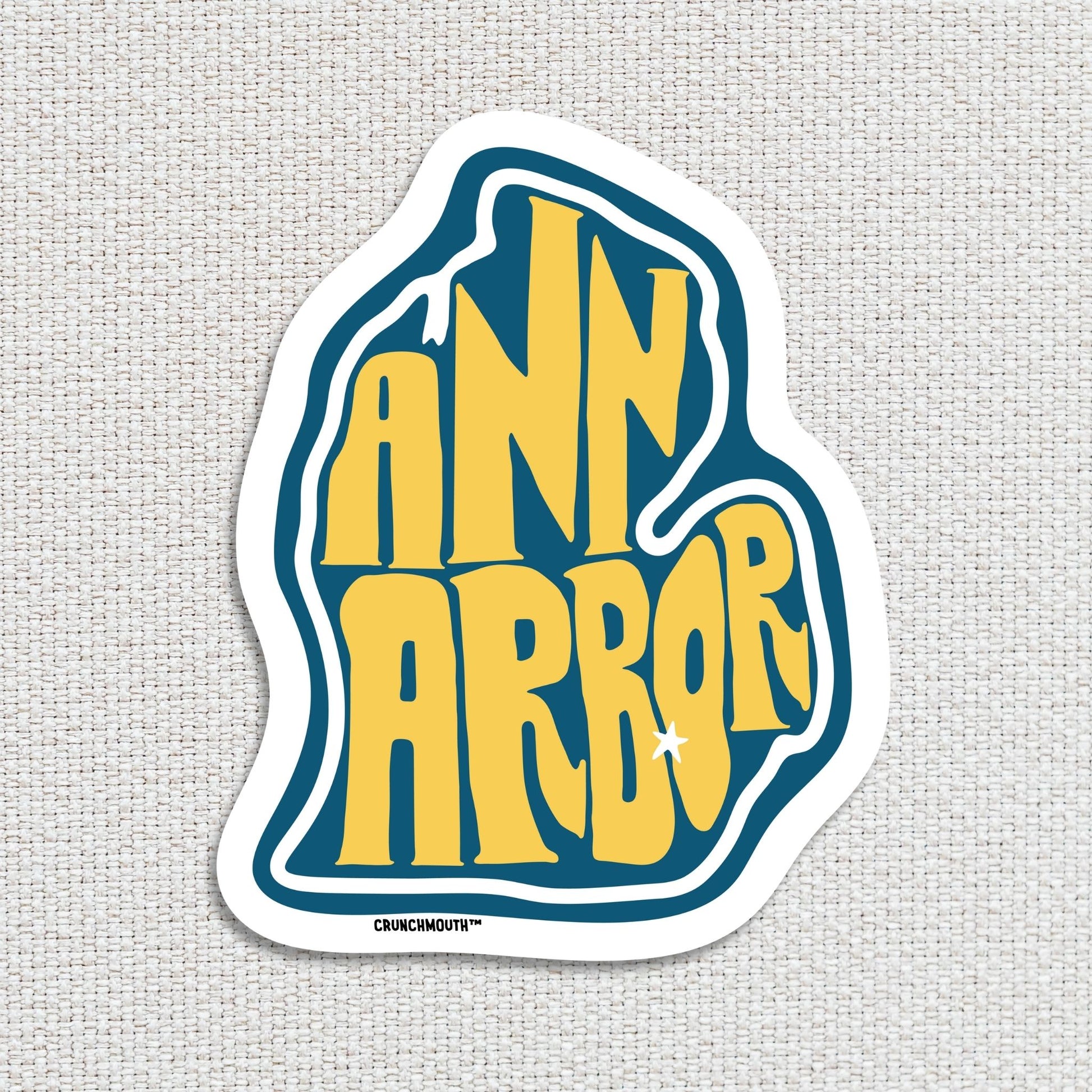 ann arbor travel luggage sticker, textured fabric background