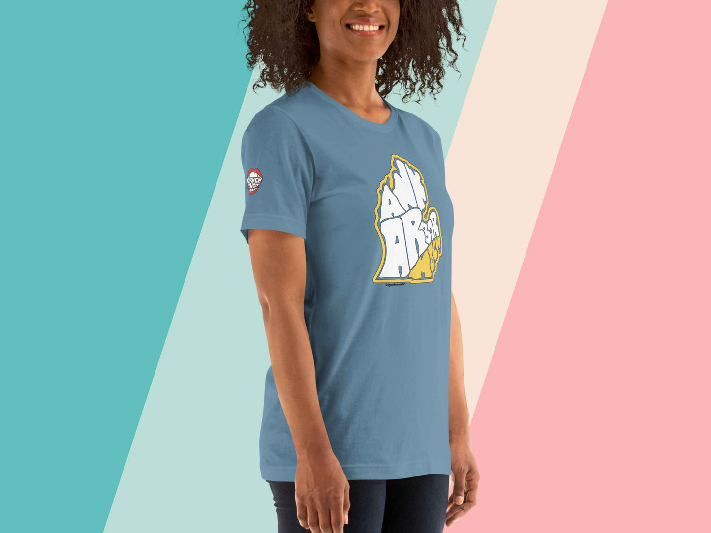 ann arbor shirt, retro t shirts, front right, female model, pastel stripe background