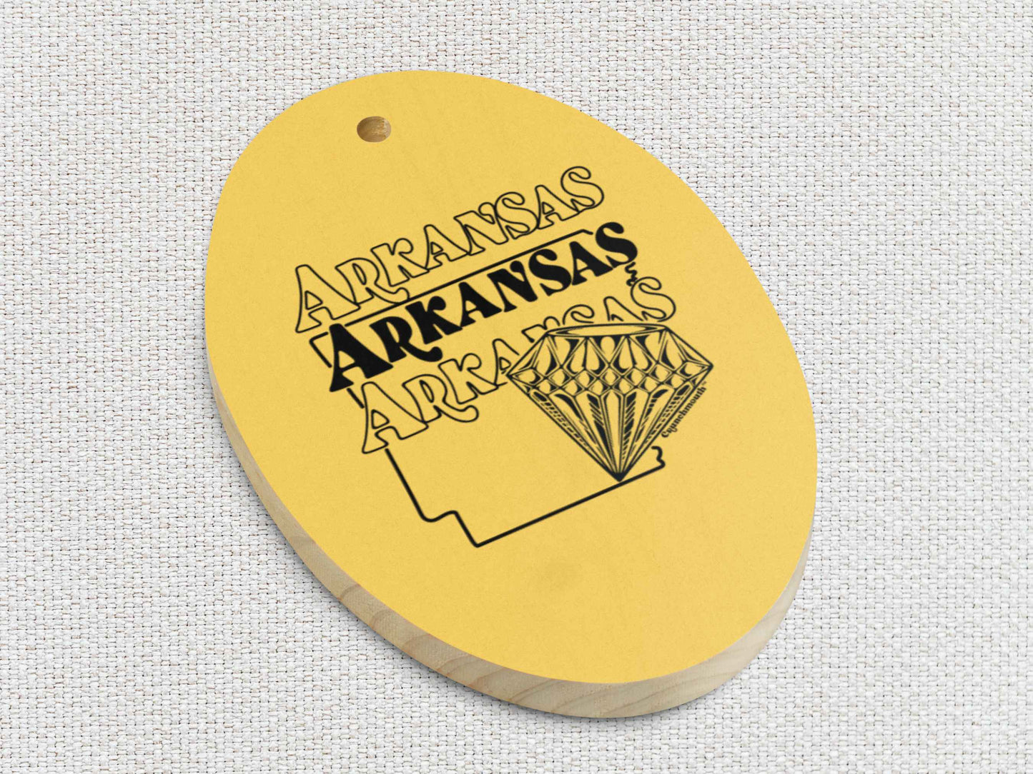 arkansas diamond state Christmas ornament, front lower left side, white textured background