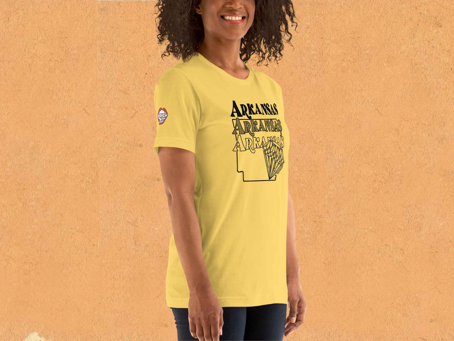 arkansas shirt, souvenir t shirts, female model, front right, orange textured background