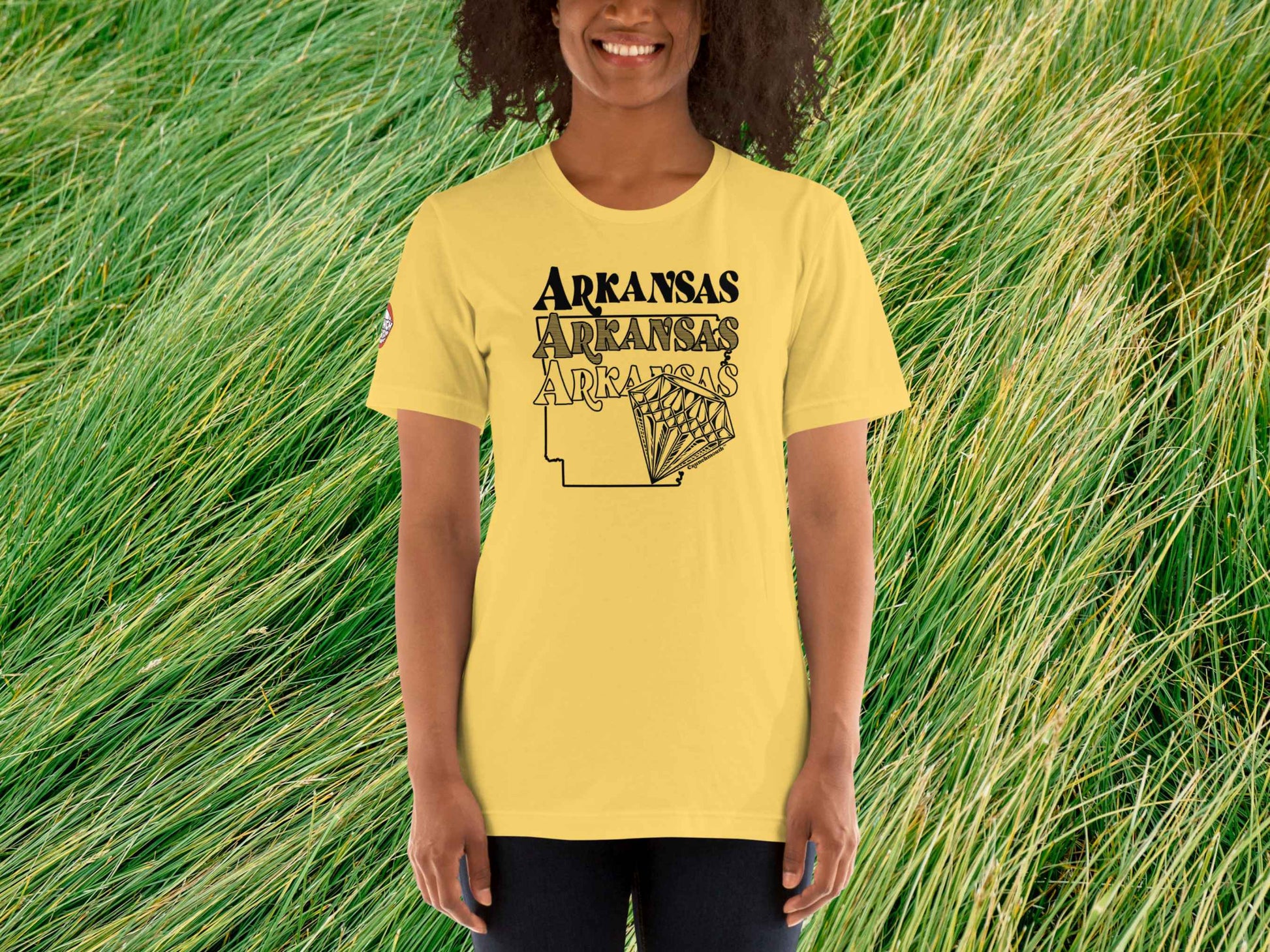 arkansas shirt, souvenir t shirts, female model, front, green grass background