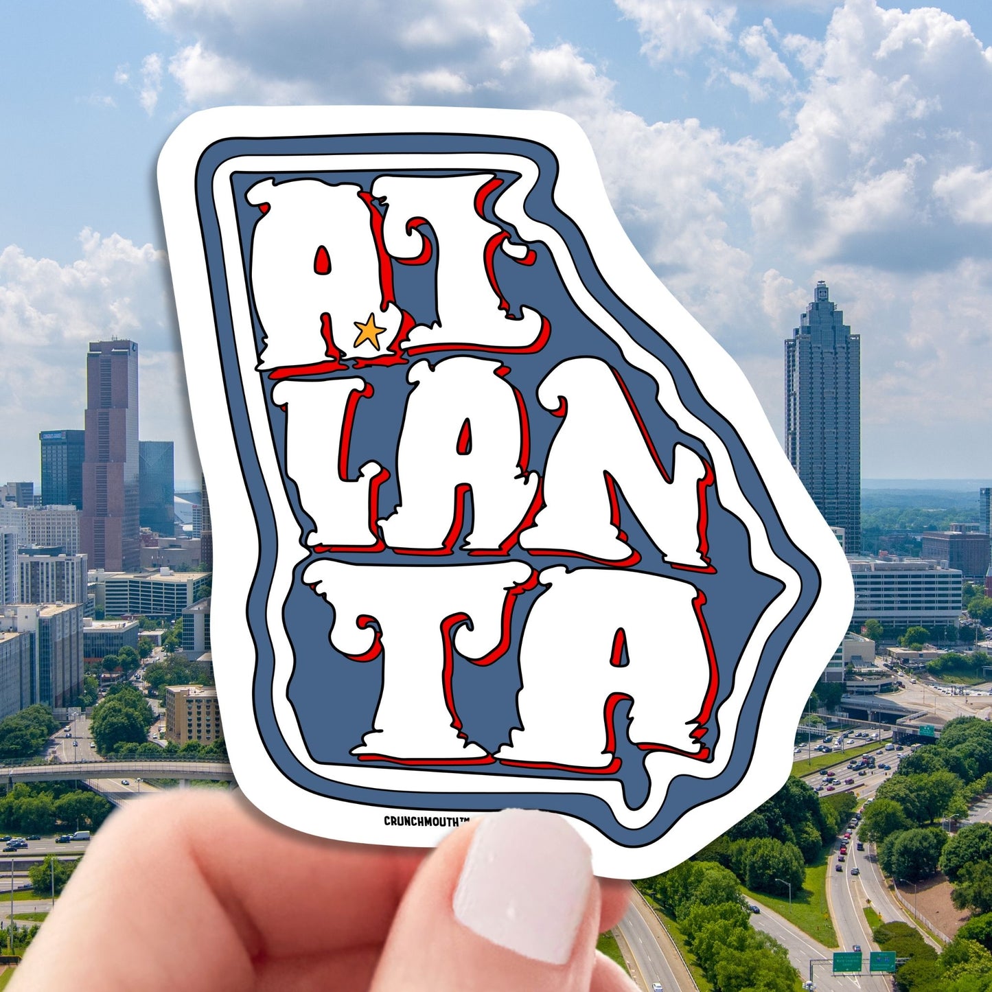 atlanta travel luggage sticker, hand display, cityscape background