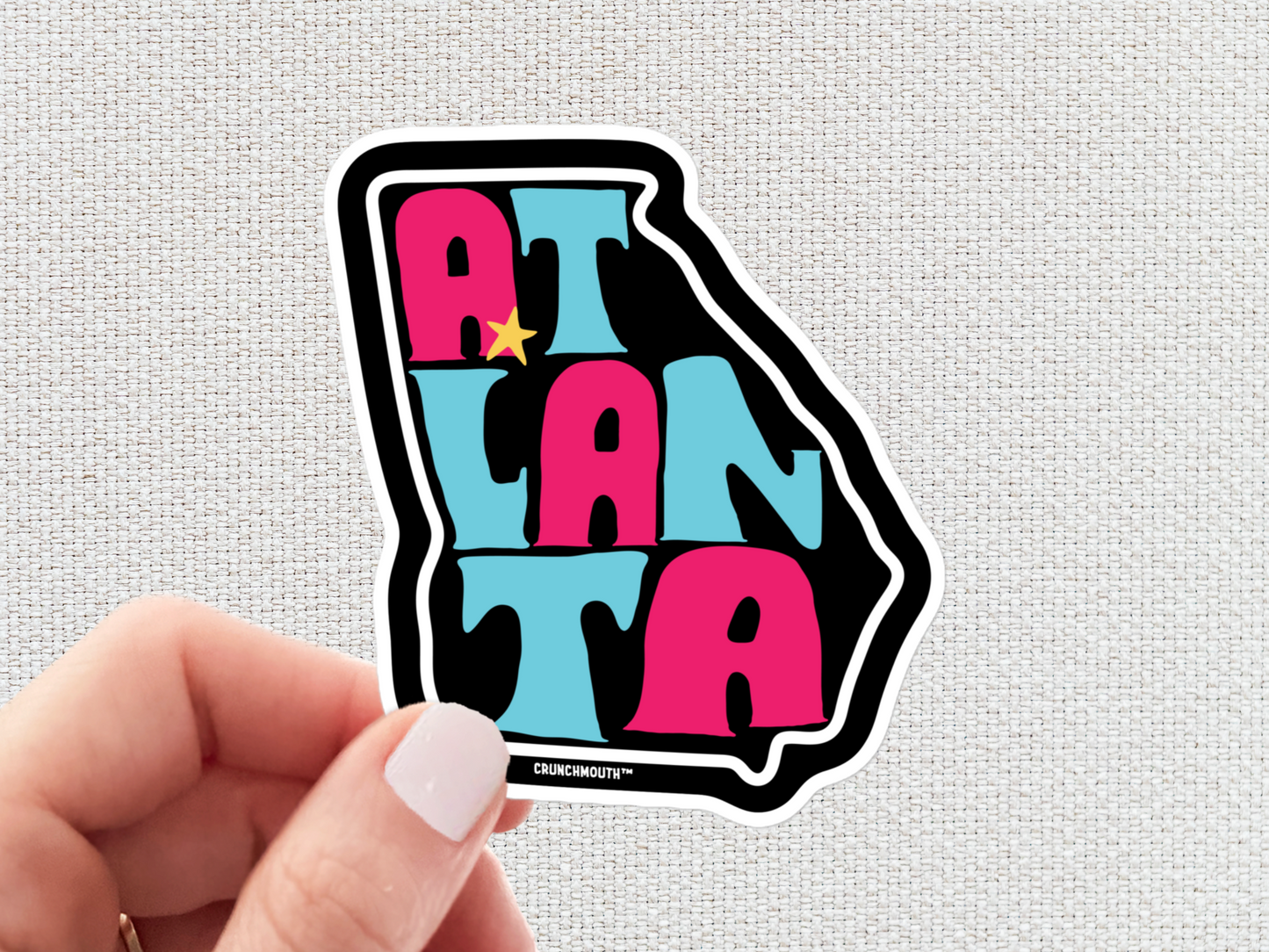 atlanta sticker, hand display, white textured background