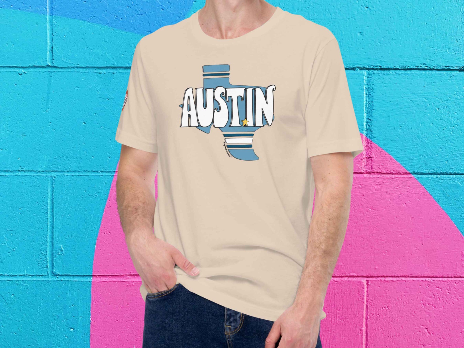 austin texas shirt, male model, front, vibrant color cinder block wall background