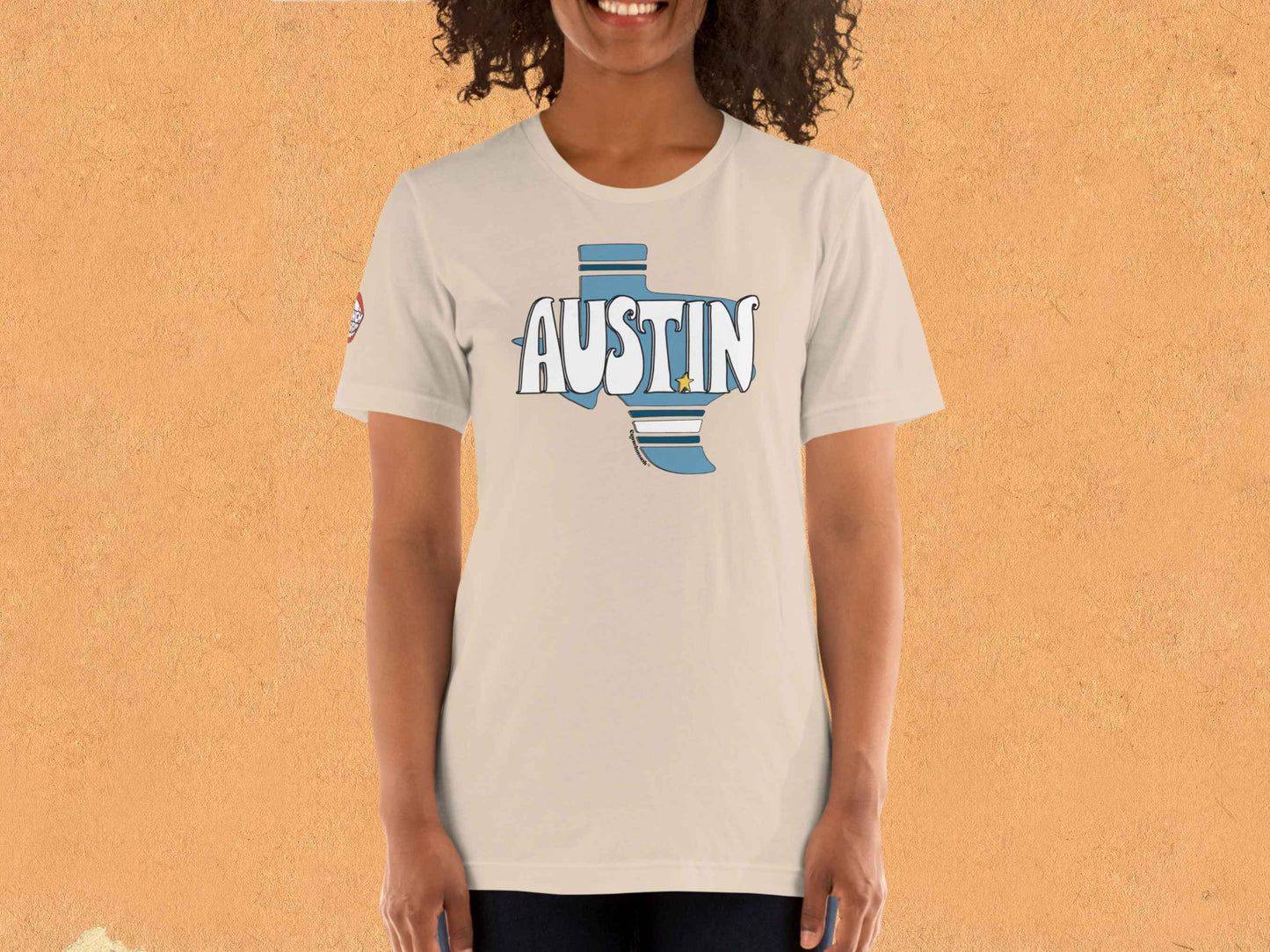 austin texas shirt, female model, front, orange textured wall background