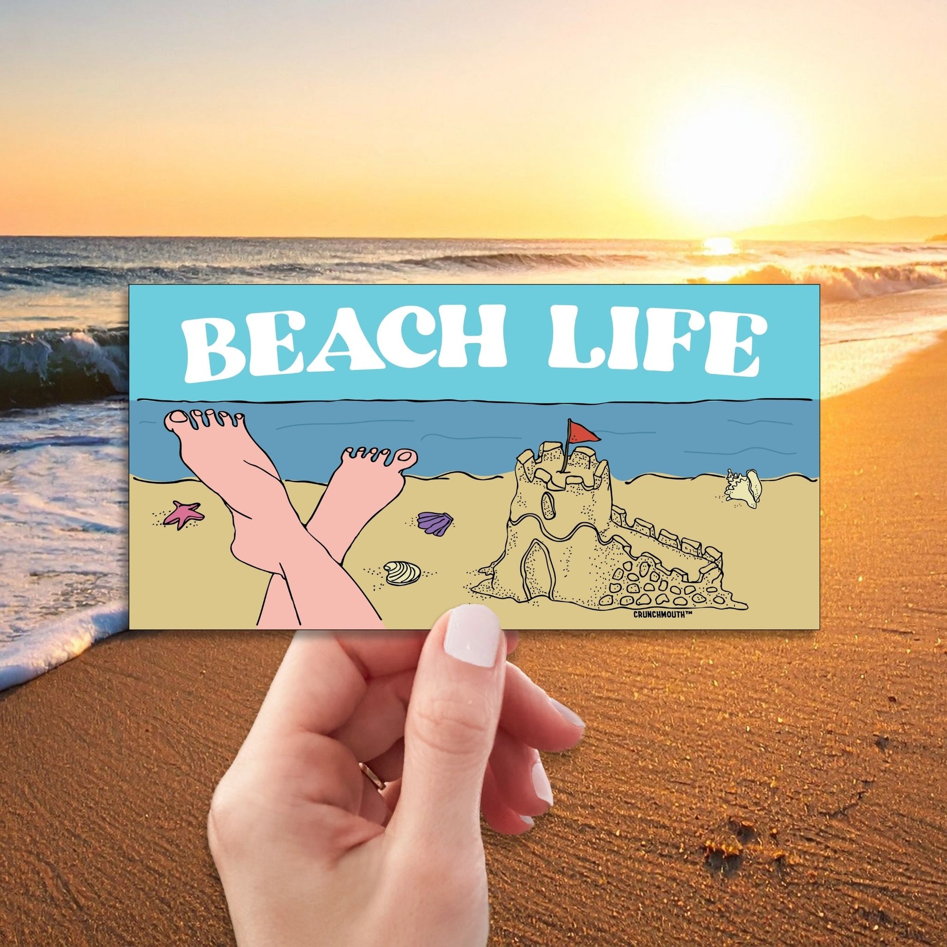 beach life bumper sticker, hand display, beach background
