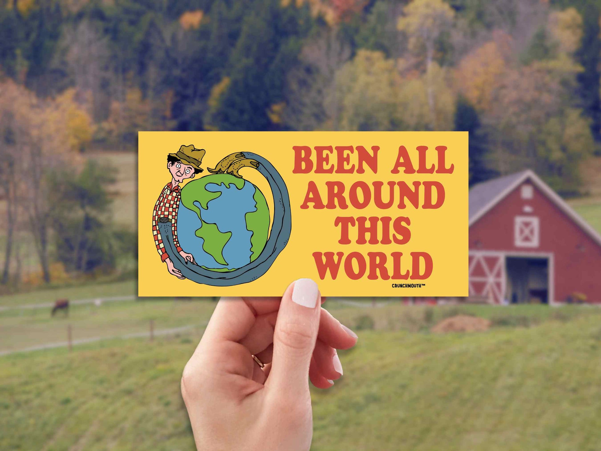 been all around this world bumper sticker, hand display, farm countryside background