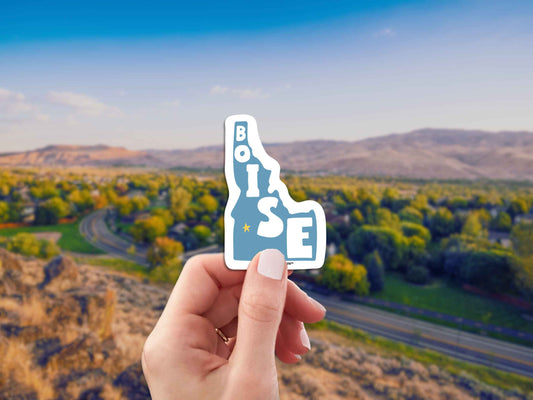 boise travel luggage sticker, hand display, landscape background