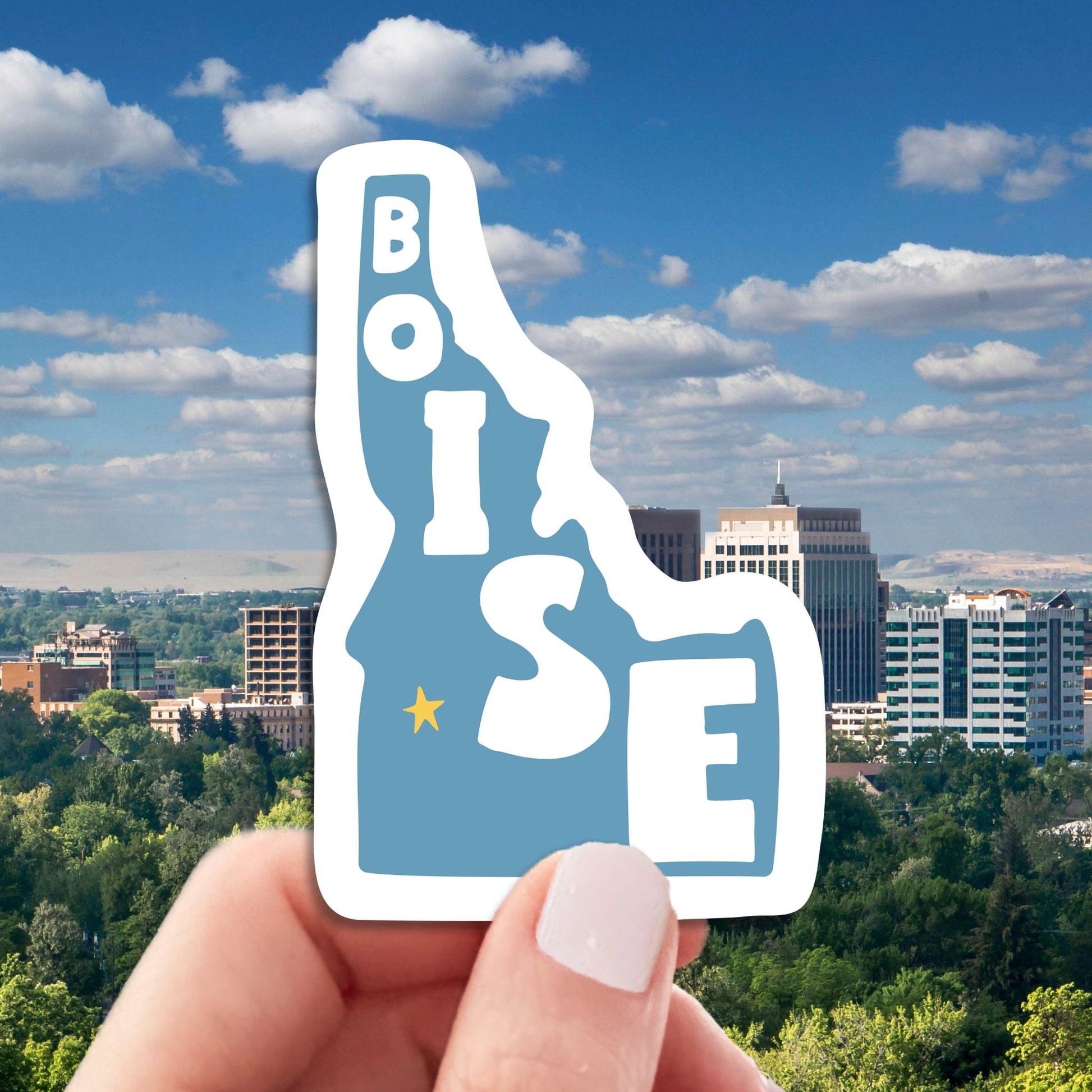 boise travel luggage sticker, hand display, boise skyline background
