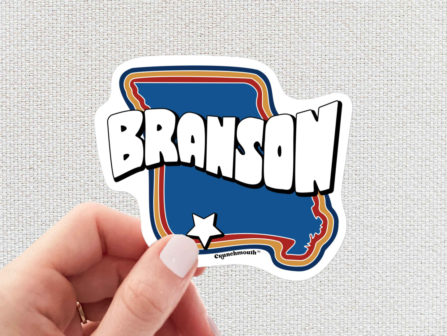 branson travel luggage sticker, hand display, white textured background