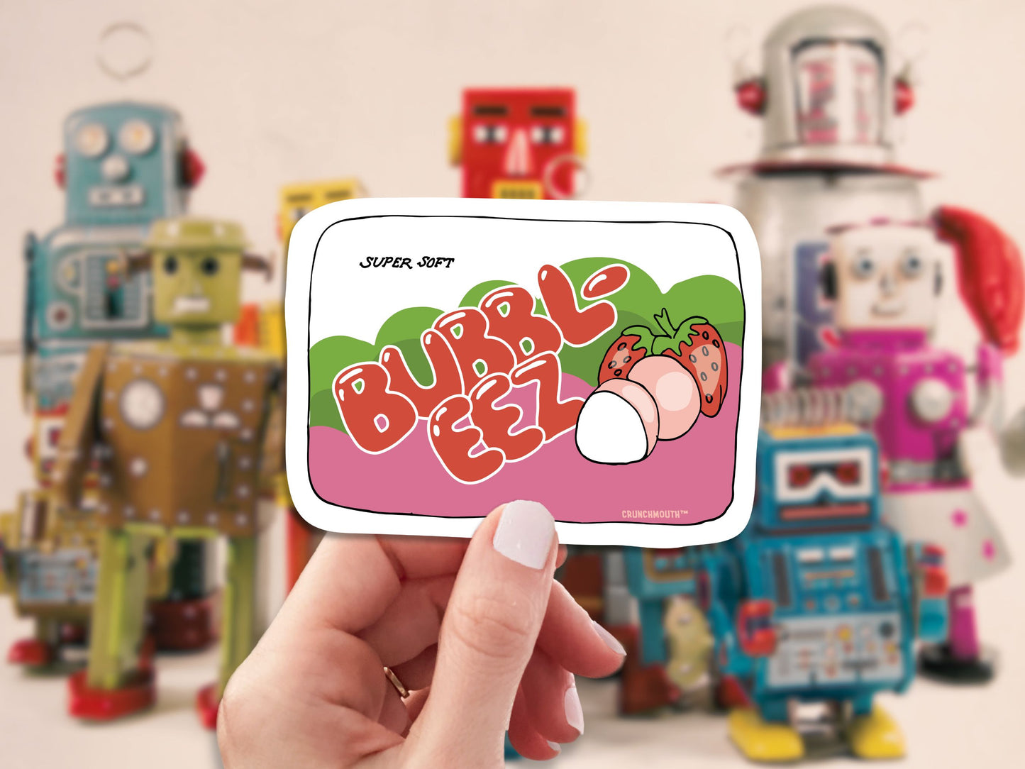 bubble ease bubble gum sticker, hand display, vintage toy robots background