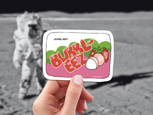 bubble ease bubble gum sticker, hand display, moon astronaut background