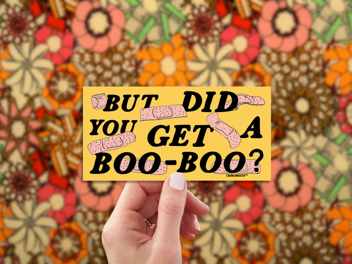 but did you get a boo boo bumper sticker, hand display, 1960s floral pattern fabric background