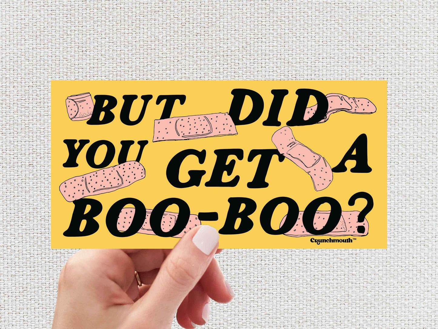 but did you get a boo boo? bumper sticker, hand display, white textured background