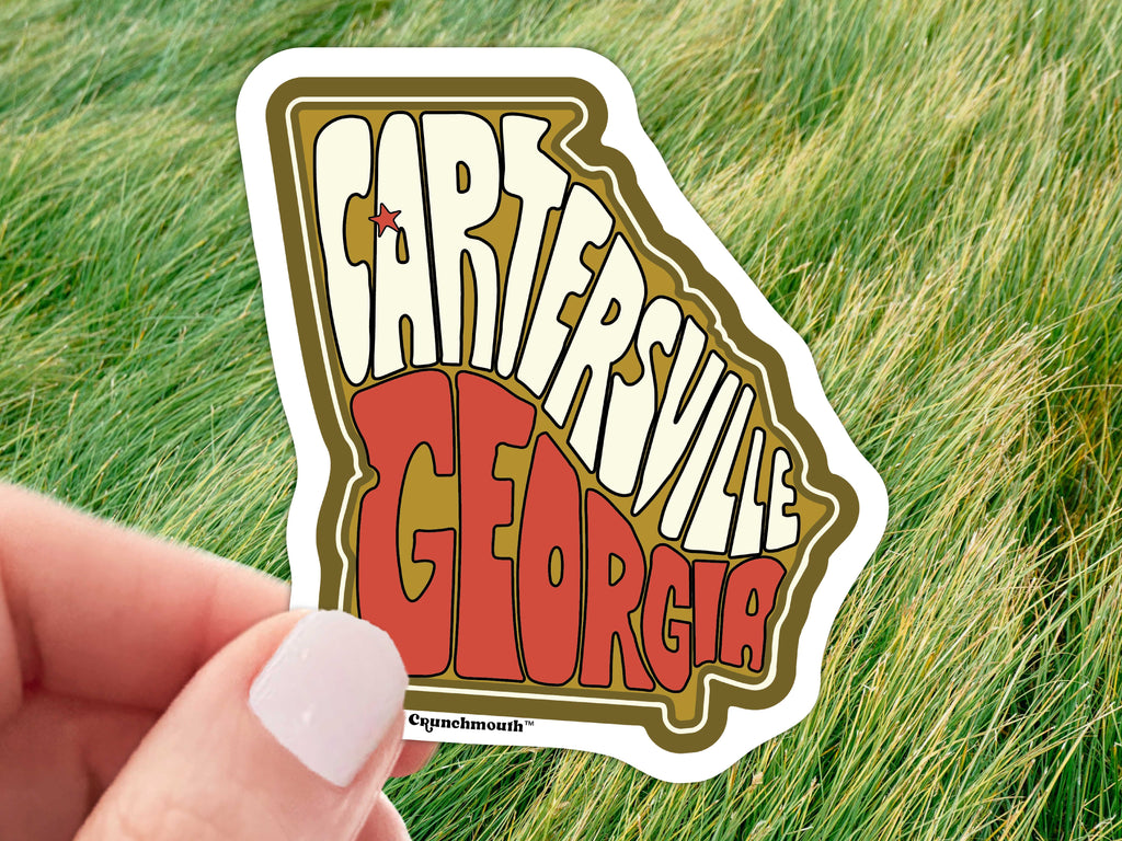 cartersville georgia vinyl sticker, hand display, grass background
