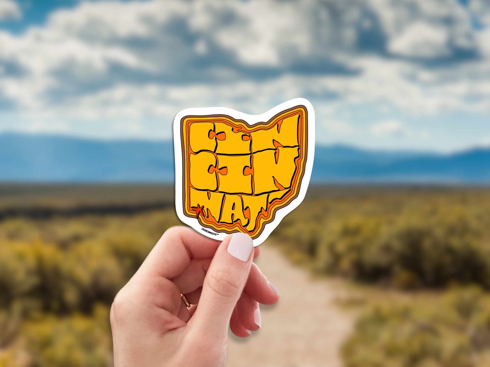 cincinnati ohio travel luggage sticker, hand display, dirt road background