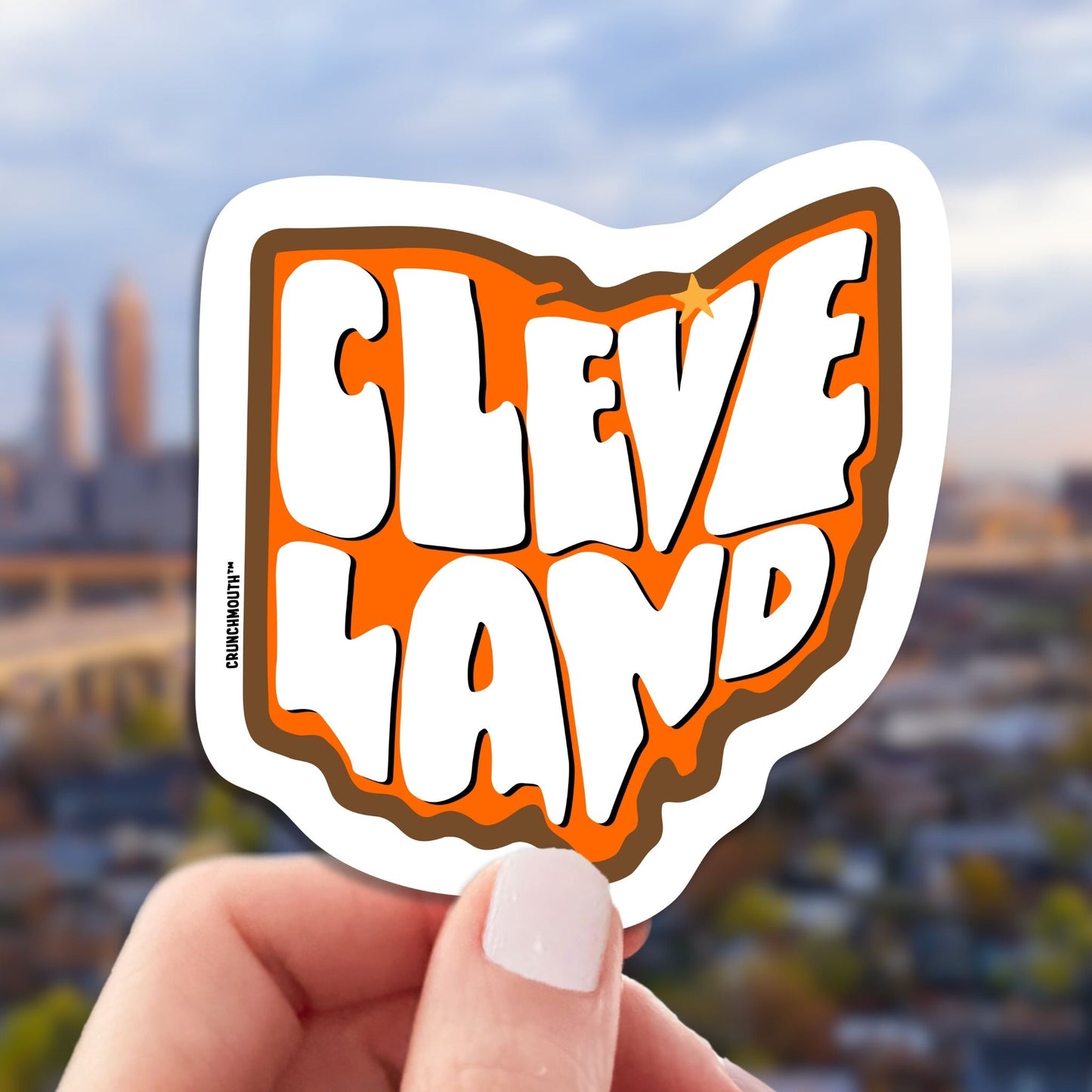 cleveland travel luggage sticker, hand display, skyline background