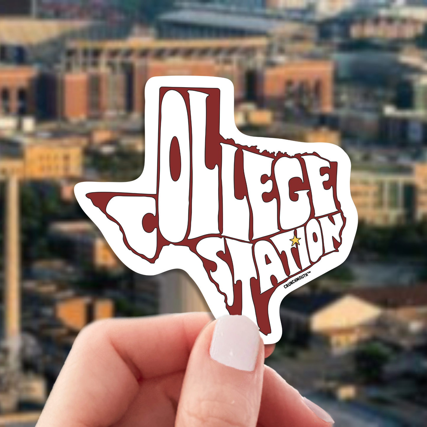 college station travel luggage sticker, hand display, cityscape background