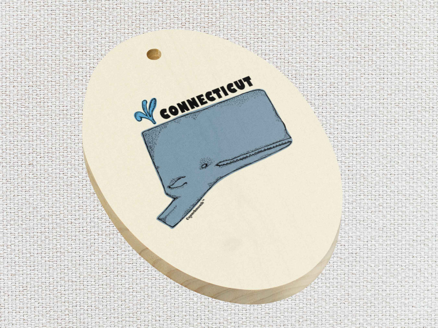 connecticut whale Christmas ornament, front lower left side, white textured background