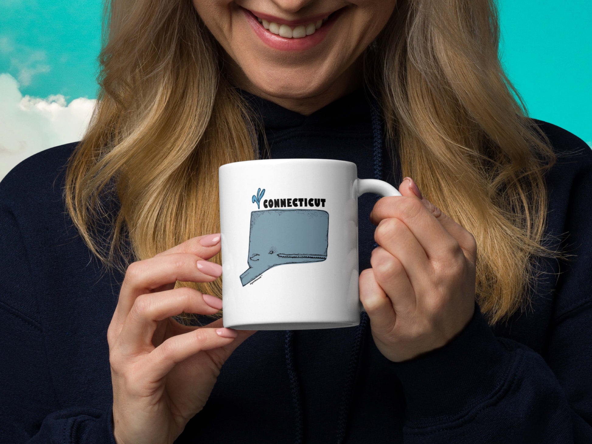 connecticut state whale coffee mug, 11oz, held in hand, cloud sky background