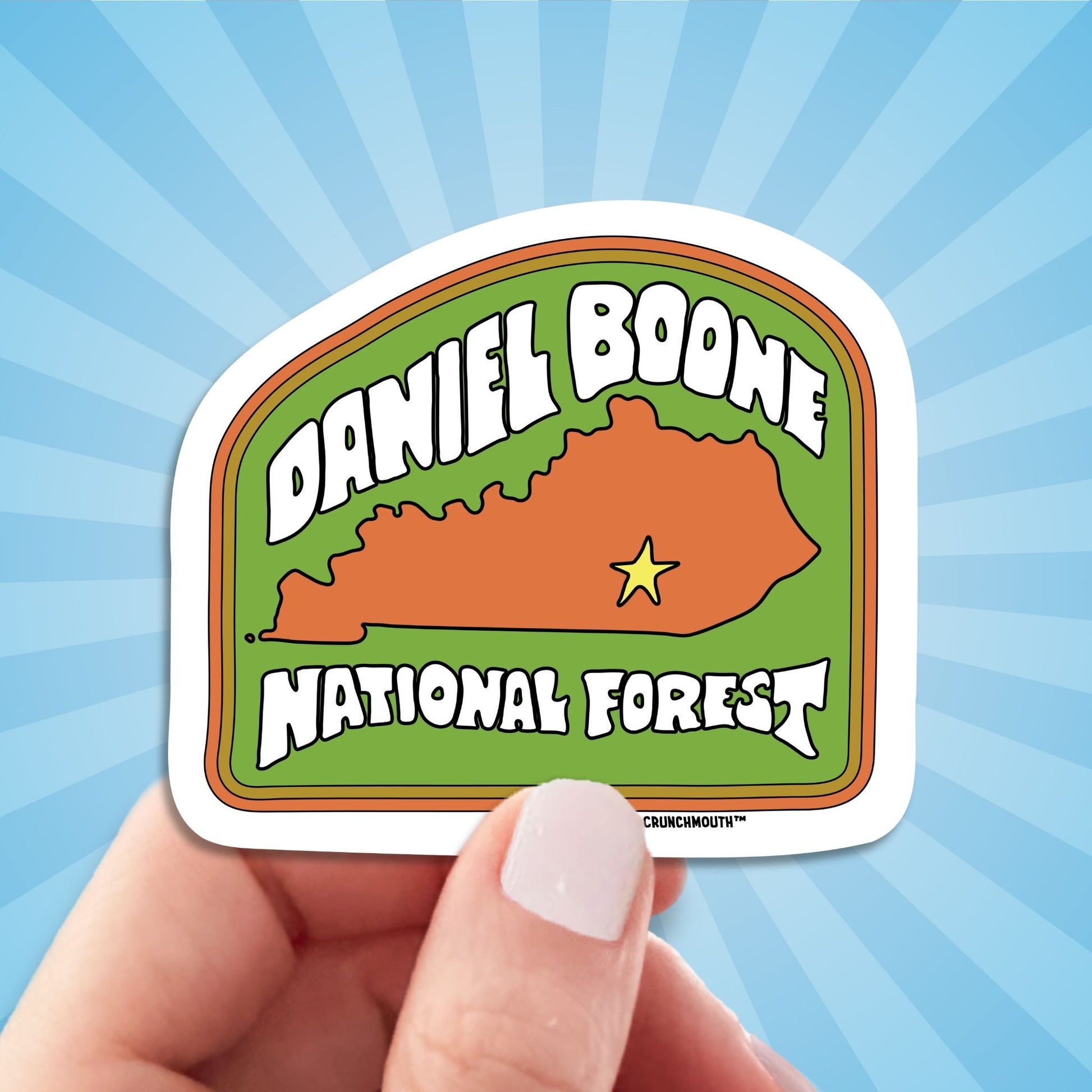 Daniel boone national forest travel luggage sticker, hand display, sun rays design background
