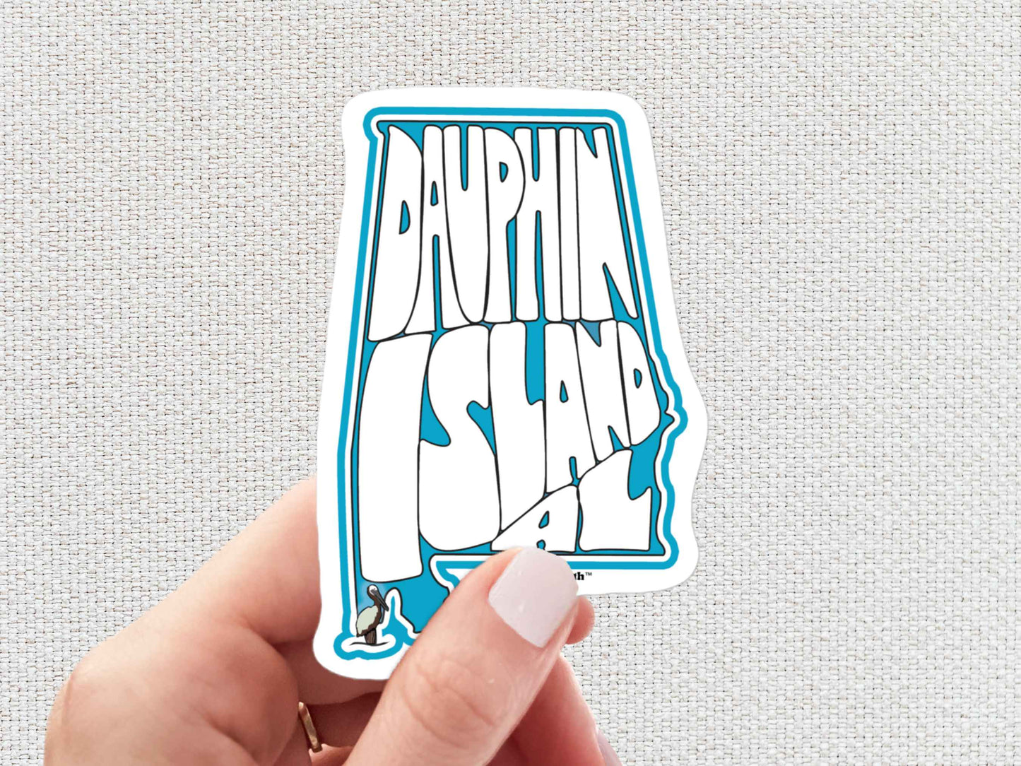 dauphin island sticker, hand display, white textured background