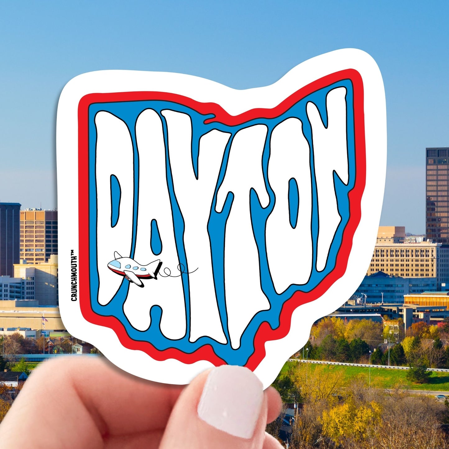 dayton travel luggage sticker, hand display, dayton skyline background